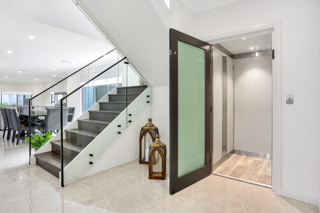 Modern home interior with glass staircase and compass lift