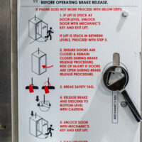 Close-up of safety reminders on a Compass home lift