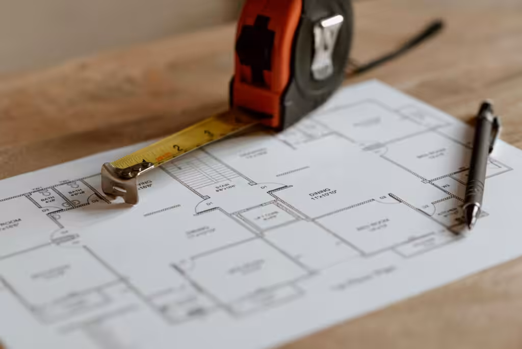 Tape measure on house floor plan by builders.