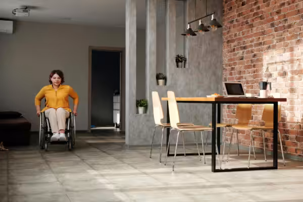 Woman in wheelchair in a dining area with a modern lift installed